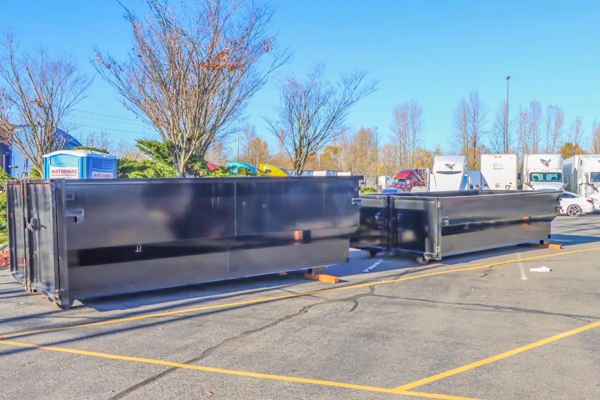 Professional dumpster rental service with roll-off container on residential driveway in Potomac